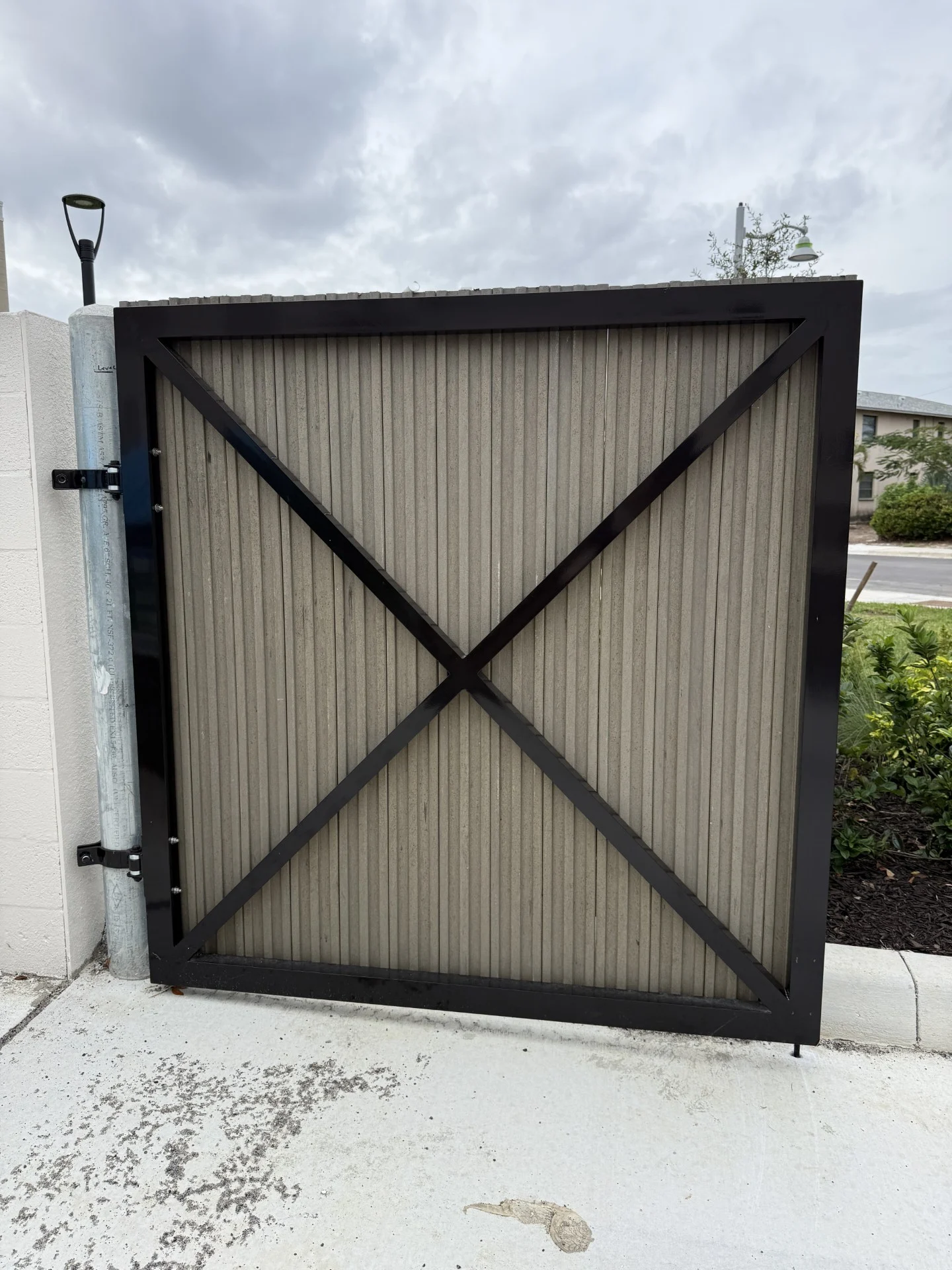 Brooks & Freund – Bimini Square – Dumpster Gate (1) Louvered aluminum dumpster enclosure gate at Bimini Square