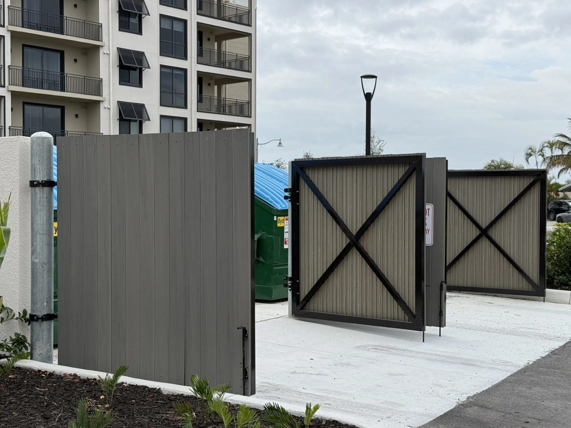 Brooks & Freund – Bimini Square – Dumpster Gate Louvered aluminum dumpster enclosure gate at Bimini Square