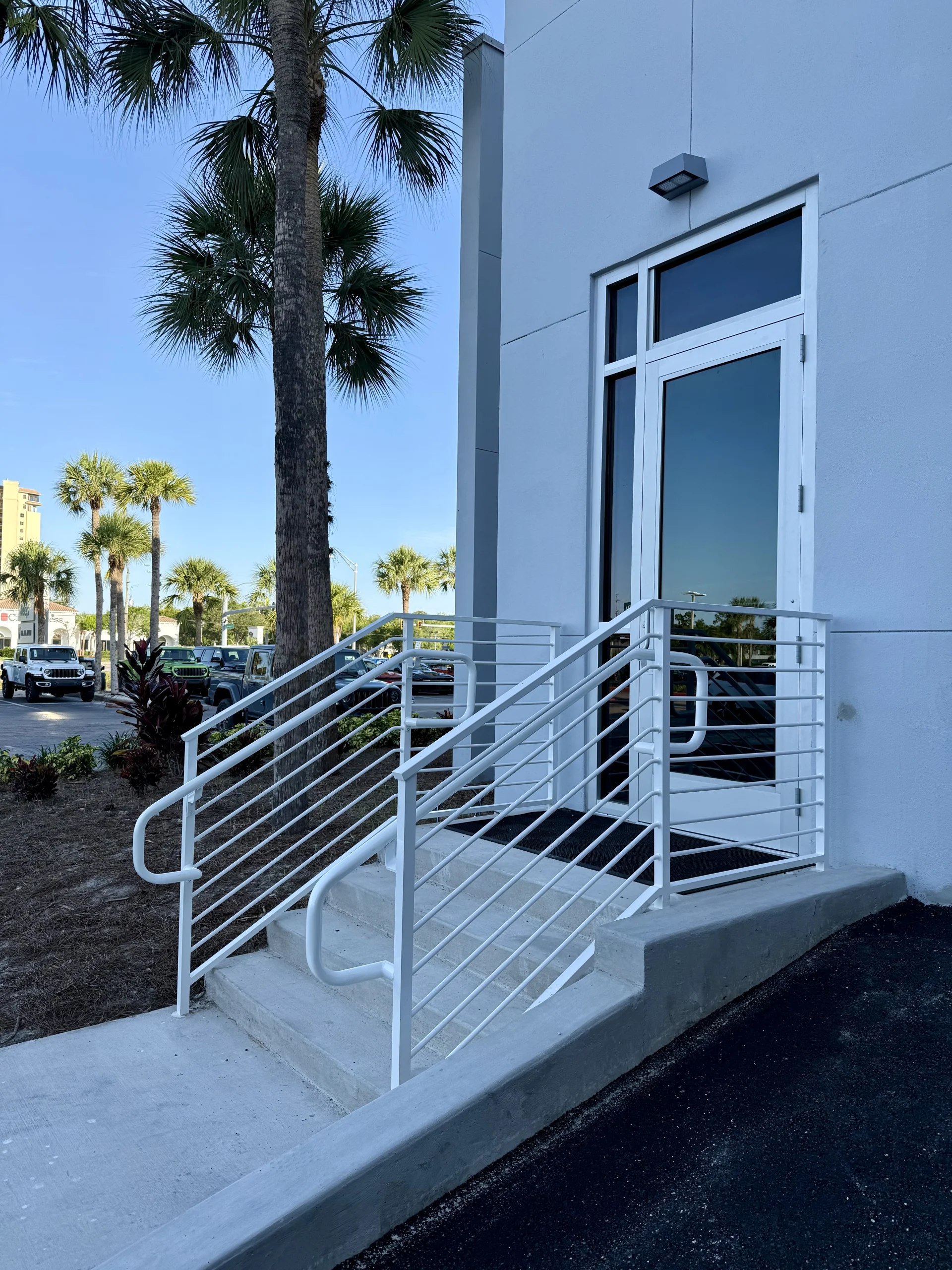 Envirostruct – CDJR – Galena – Horizontal Rod Rail with Grab Rail (1) Horizontal aluminum rod railing with a continuous top cap at Galena