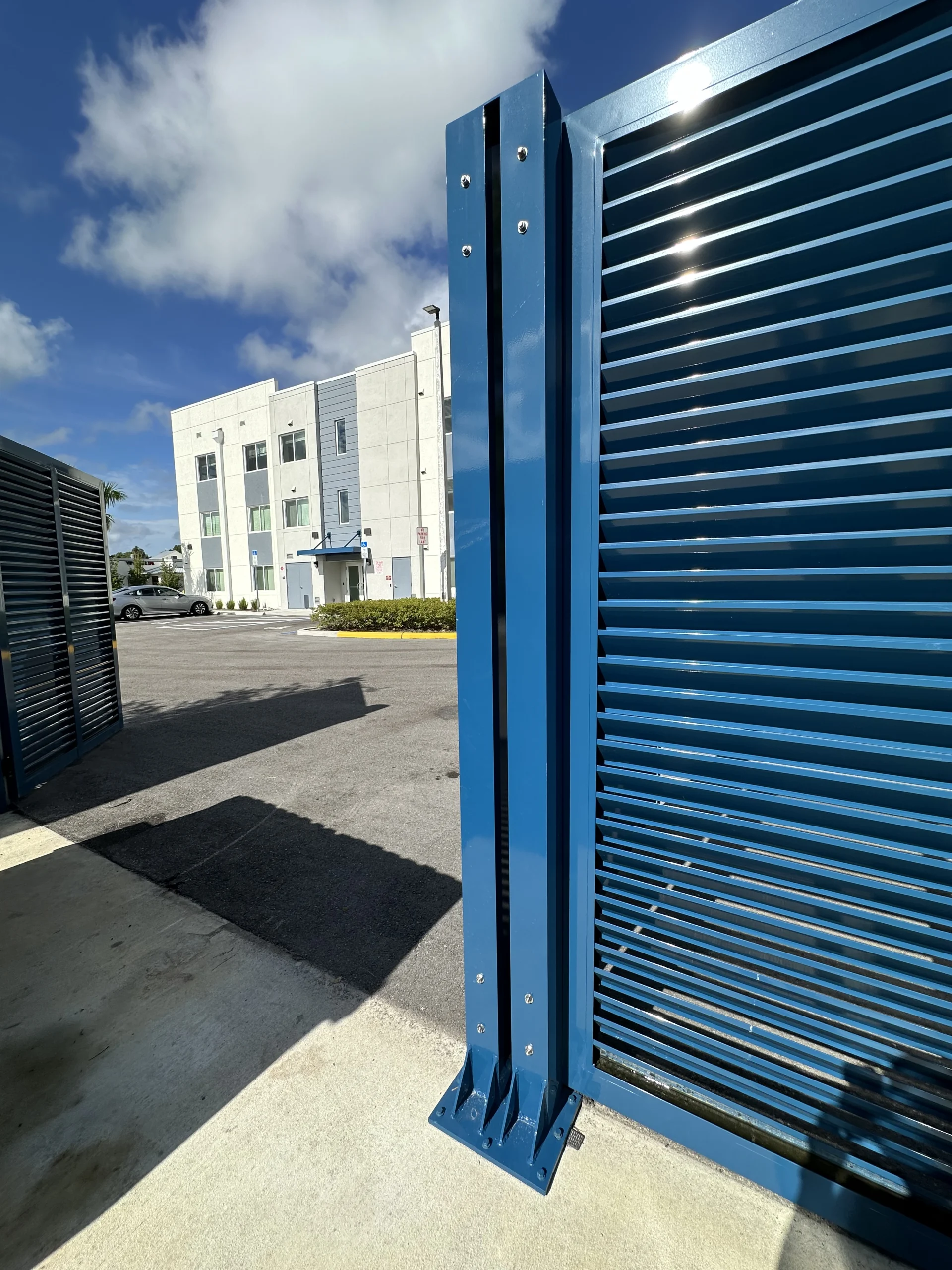 FL Star – Dumpster Gates – Louvered – Vanderbilt Apartments (1) Louvered aluminum dumpster enclosure gate at Vanderbilt Apartments