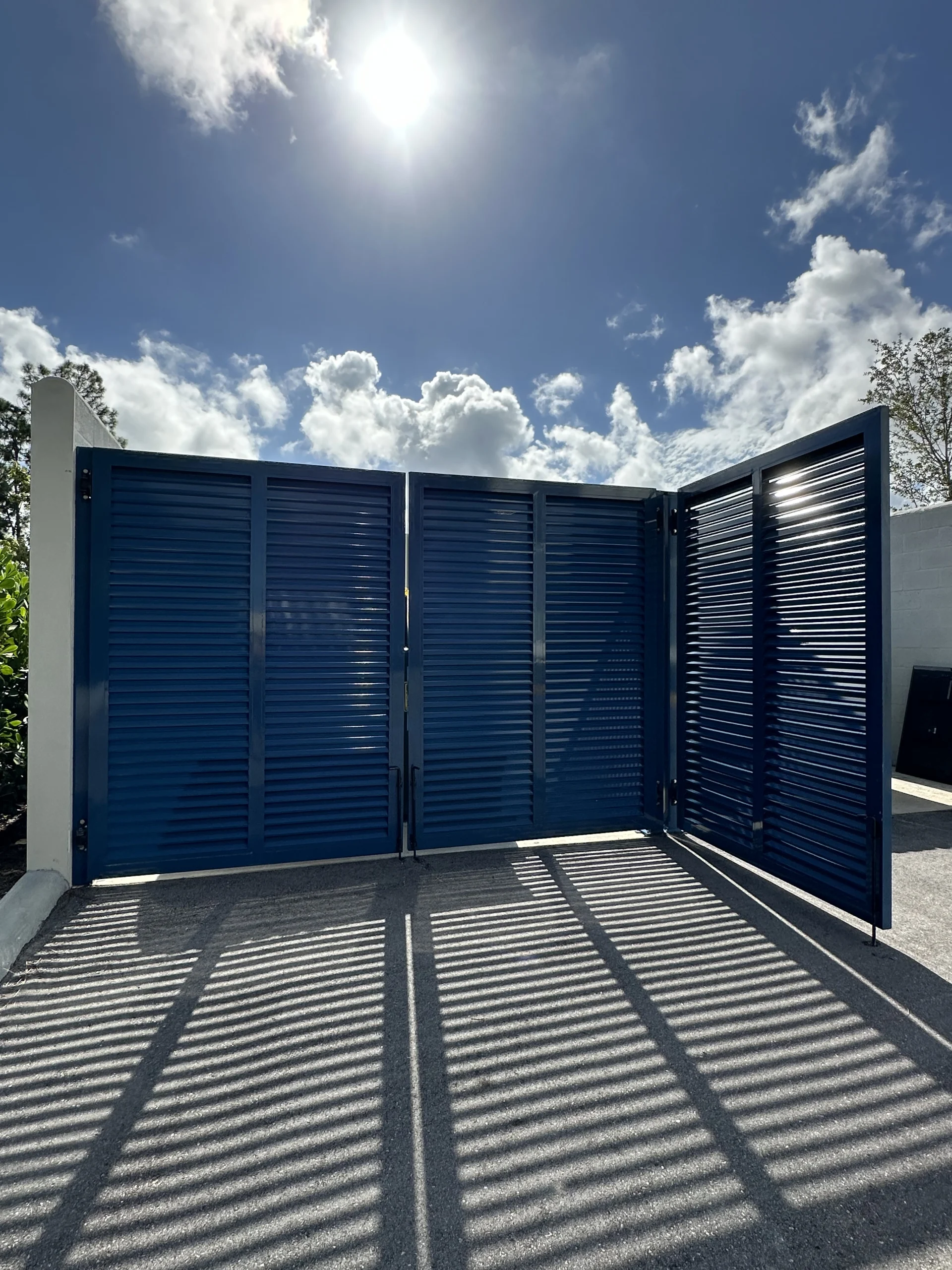 FL Star – Dumpster Gates – Louvered – Vanderbilt Apartments (2) Louvered aluminum dumpster enclosure gate at Vanderbilt Apartments
