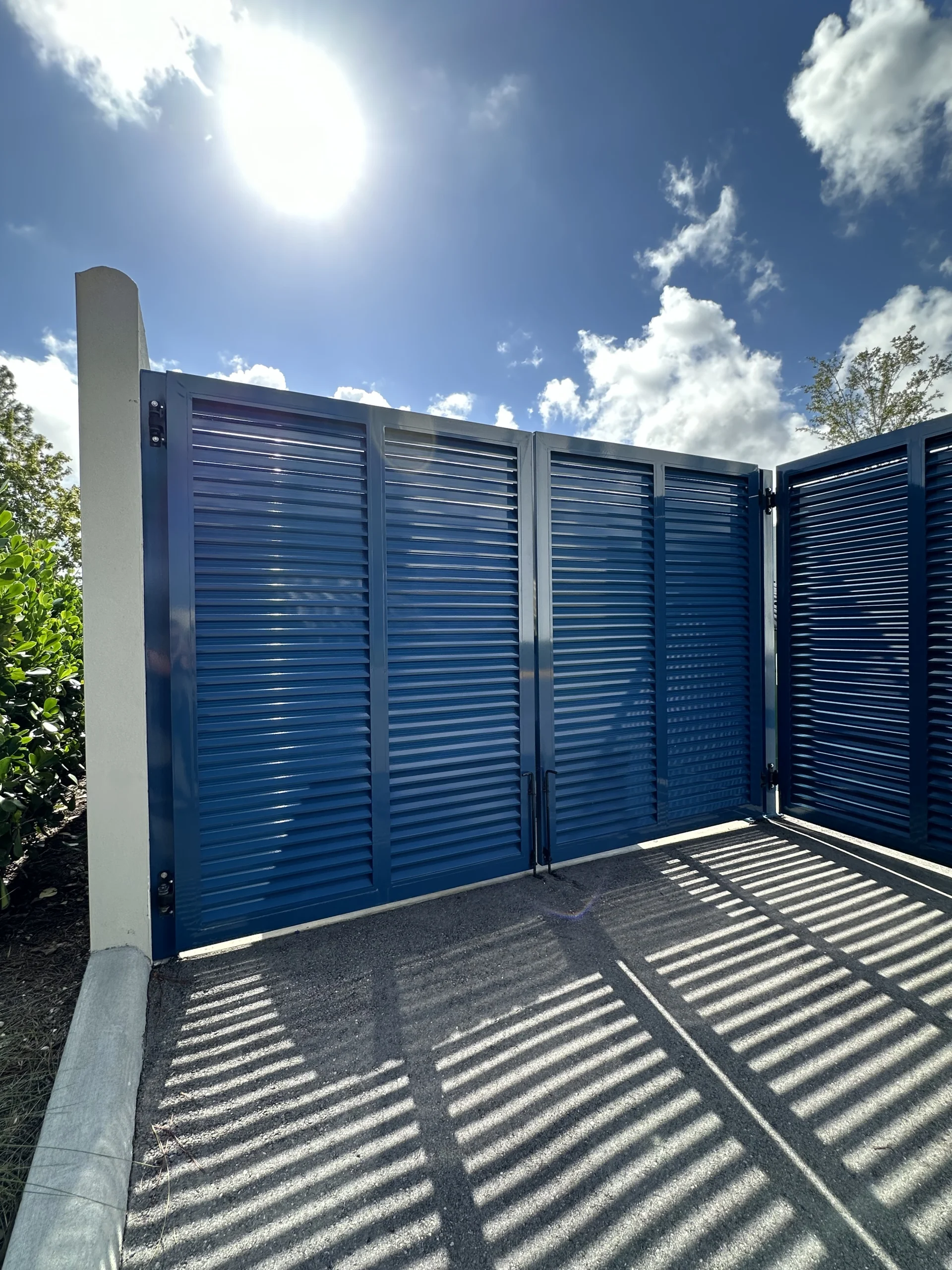 FL Star – Dumpster Gates – Louvered – Vanderbilt Apartments (3) Louvered aluminum dumpster enclosure gate at Vanderbilt Apartments