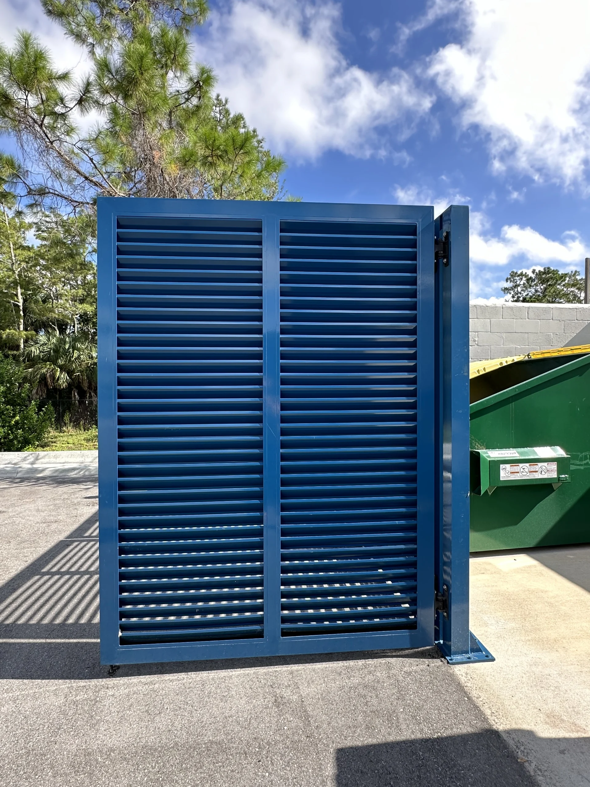 FL Star – Dumpster Gates – Louvered – Vanderbilt Apartments (7) Louvered aluminum dumpster enclosure gate at Vanderbilt Apartments