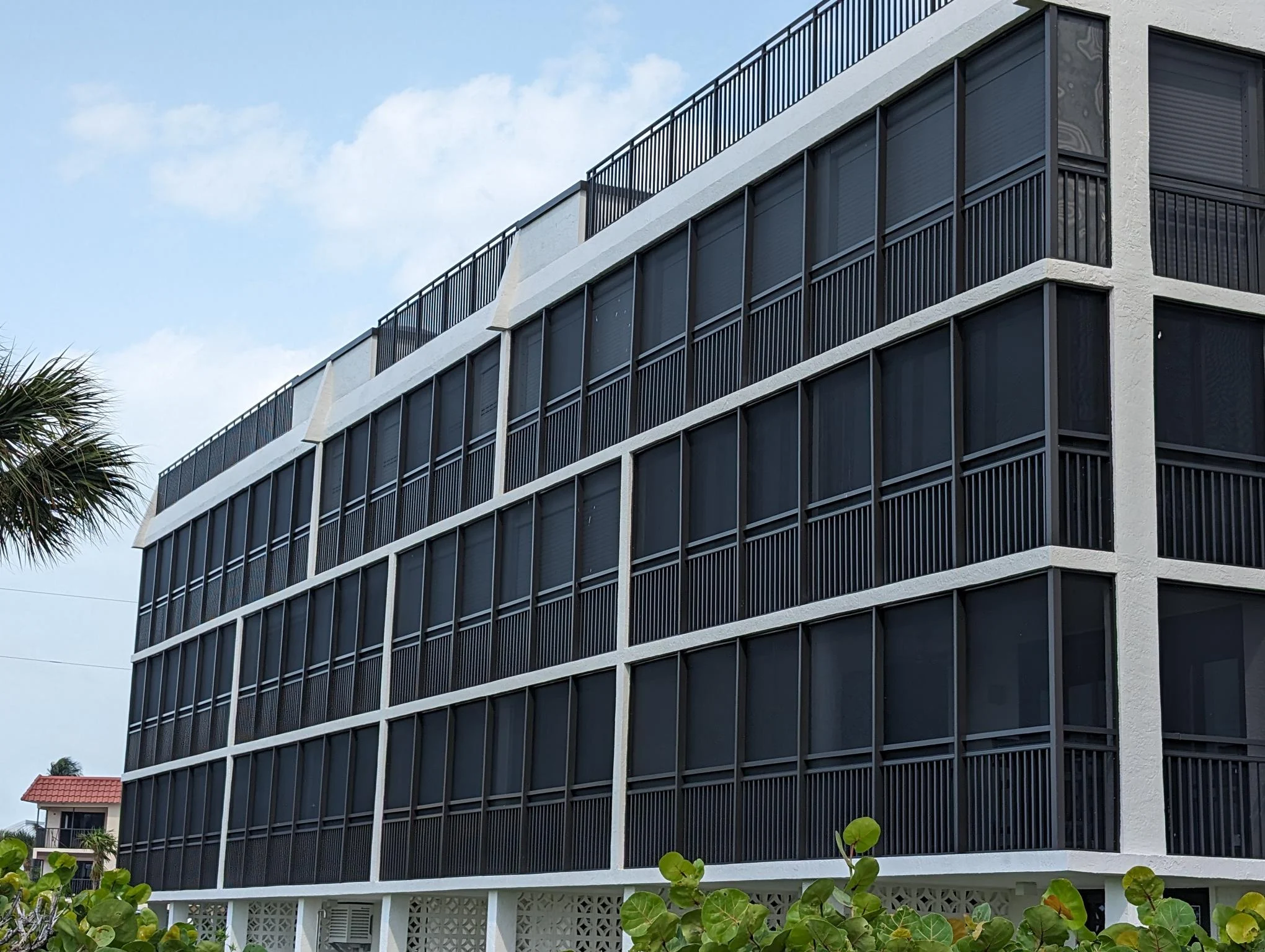 Aluminum condo screen wall on a balcony at White Pelican